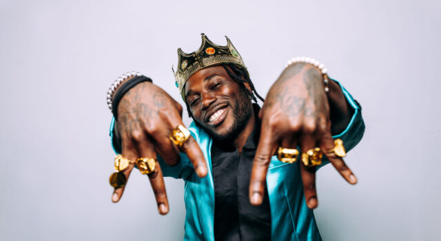 portrait of an hip hop music musician. Cinematic image of a man wearing party clothes and jewels